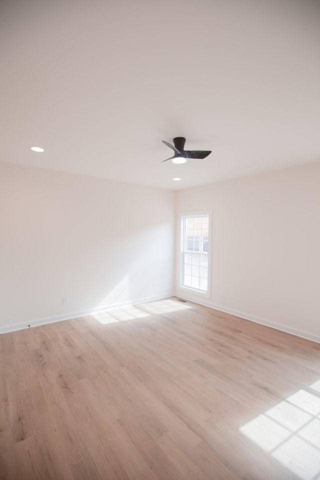 unfurnished room featuring ceiling fan and light hardwood / wood-style floors