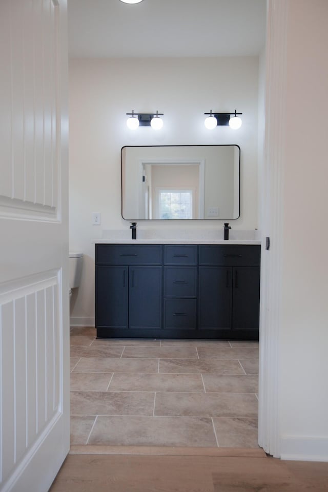 bathroom with toilet and vanity