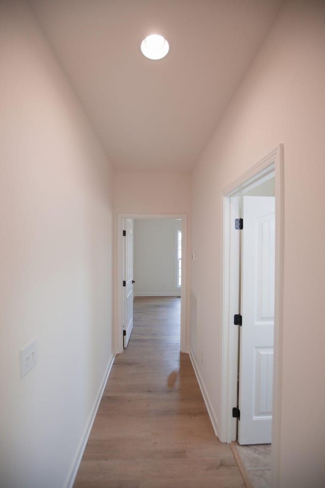 hall with light hardwood / wood-style floors