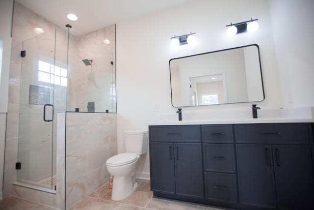 bathroom with toilet, vanity, tile patterned flooring, and a shower with door