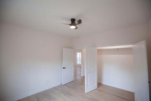 unfurnished bedroom with ceiling fan and light hardwood / wood-style floors