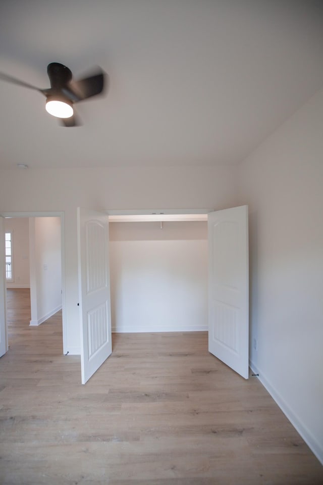 additional living space with ceiling fan and light wood-type flooring