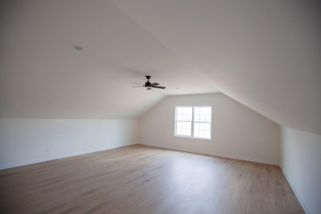 bonus room with vaulted ceiling and light hardwood / wood-style flooring