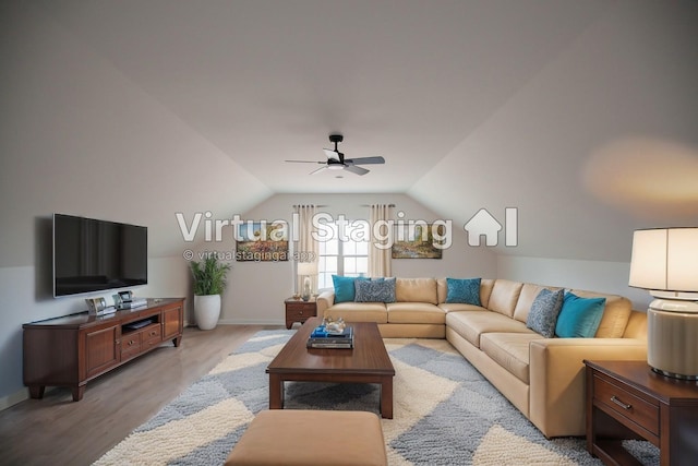 living room featuring ceiling fan, light hardwood / wood-style flooring, and vaulted ceiling