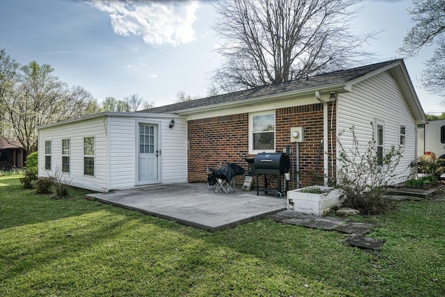 rear view of property with a patio area and a yard