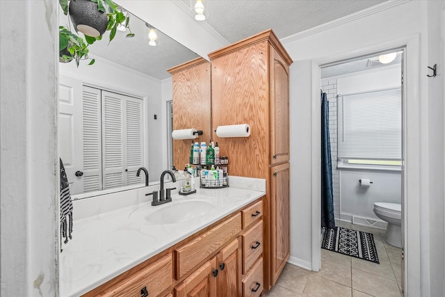 bathroom with vanity, a textured ceiling, tile patterned floors, and crown molding