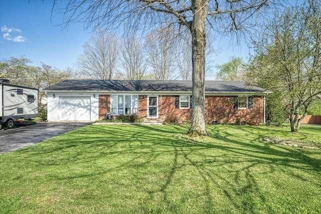 single story home featuring a front yard and a garage