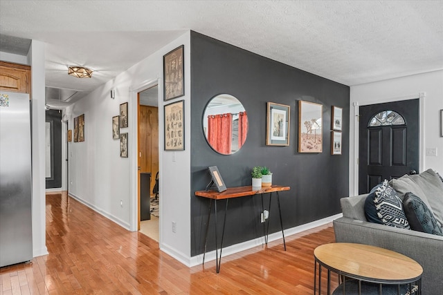 interior space featuring a textured ceiling and light wood-type flooring