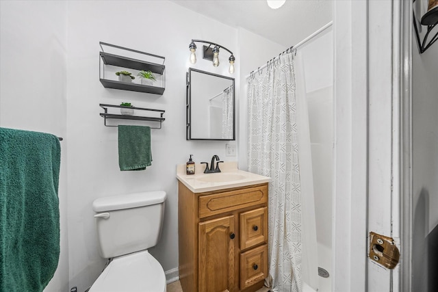 bathroom with vanity, a shower with shower curtain, and toilet