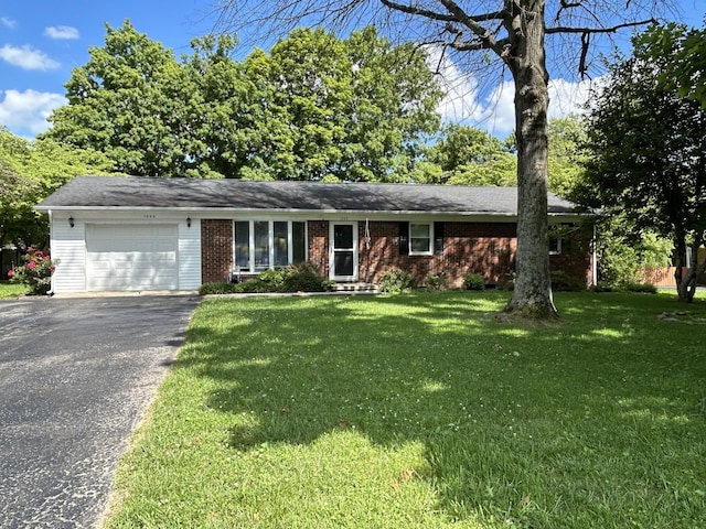 single story home with a front yard and a garage