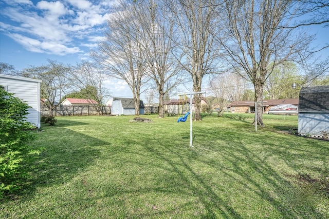 view of yard with a playground and a storage shed