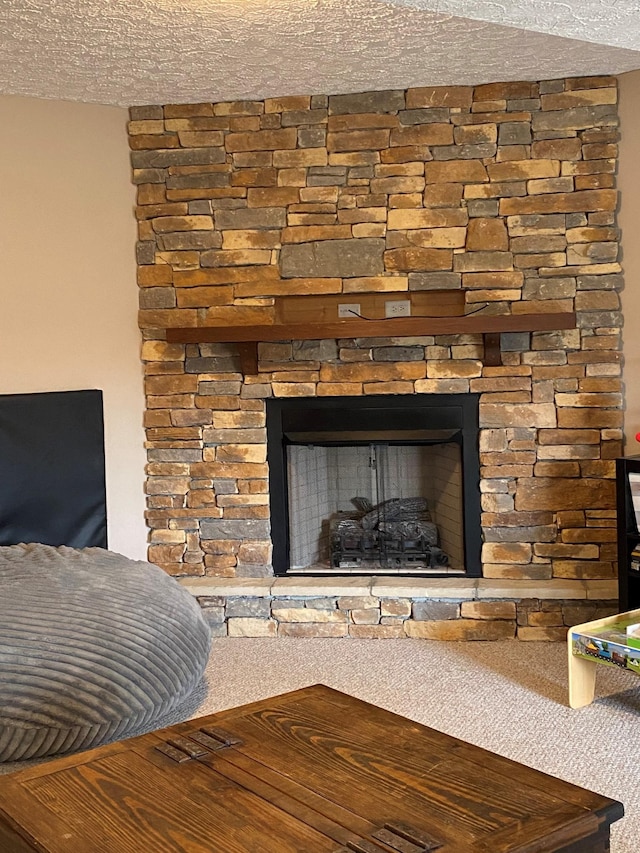 room details with a fireplace, carpet floors, and a textured ceiling