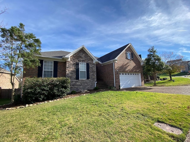 view of front of home with a front yard and a garage