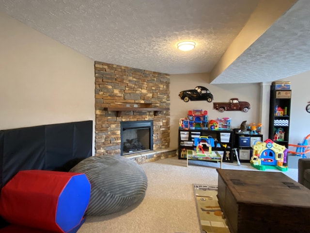 living room with a stone fireplace, carpet floors, and a textured ceiling