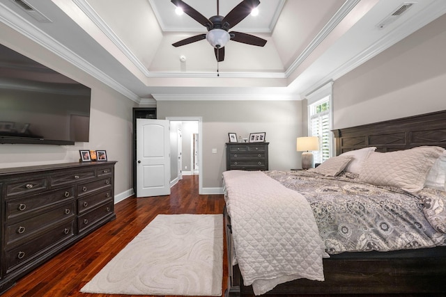 bedroom with dark hardwood / wood-style flooring, a raised ceiling, ceiling fan, and crown molding