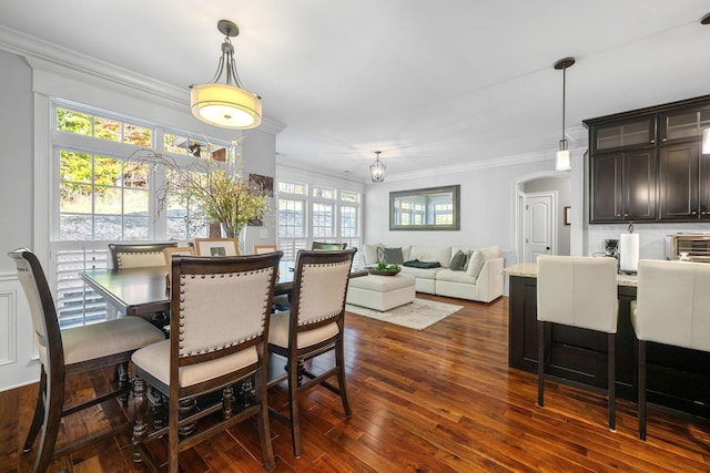 dining area featuring dark hardwood / wood-style floors and crown molding