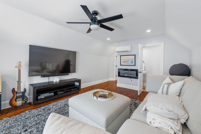 living room featuring ceiling fan, vaulted ceiling, dark hardwood / wood-style flooring, and a wall mounted AC