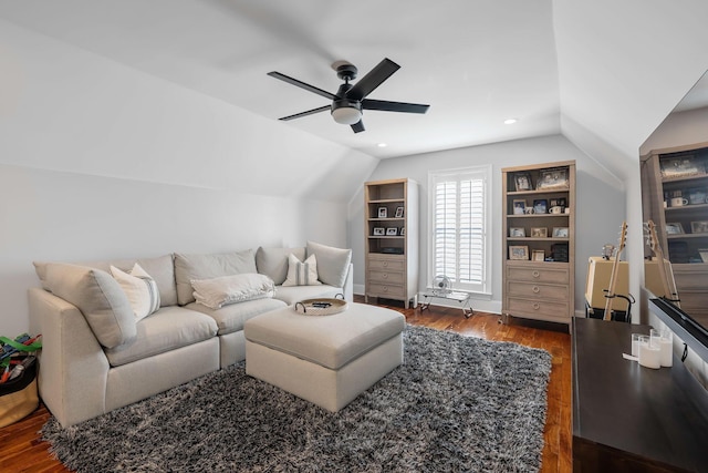 living room with ceiling fan, dark hardwood / wood-style floors, and vaulted ceiling