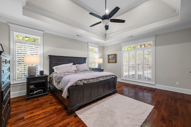 bedroom featuring ceiling fan, dark hardwood / wood-style floors, ornamental molding, and a tray ceiling