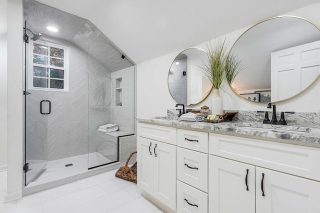 bathroom featuring tile patterned flooring, vanity, and walk in shower