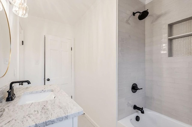 bathroom featuring vanity and tiled shower / bath