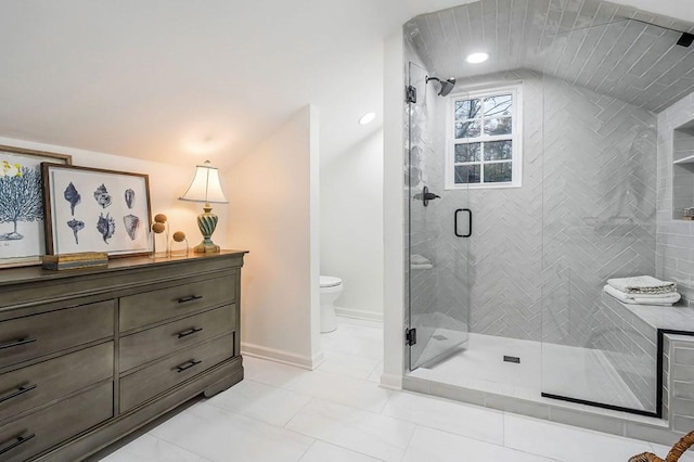 bathroom featuring tile patterned floors, lofted ceiling, toilet, and a shower with shower door