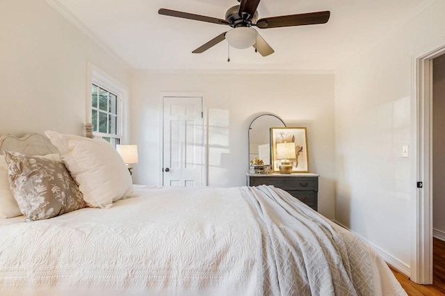 bedroom featuring wood-type flooring, ceiling fan, and ornamental molding