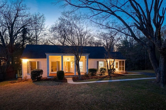 back house at dusk with a yard