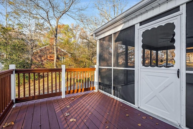 wooden deck with a sunroom