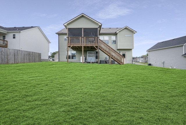 rear view of house featuring a sunroom, a yard, and cooling unit