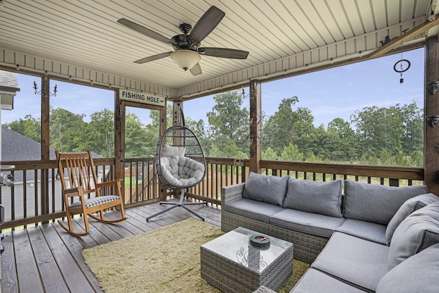 sunroom / solarium featuring ceiling fan