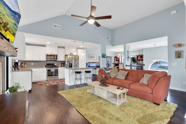 living room featuring high vaulted ceiling, dark hardwood / wood-style floors, and ceiling fan with notable chandelier