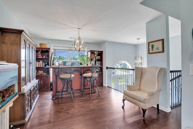 interior space featuring dark wood-type flooring, a healthy amount of sunlight, and a notable chandelier