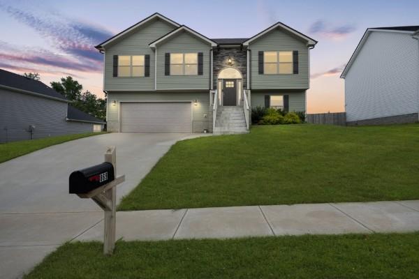 view of front of house with a garage and a yard