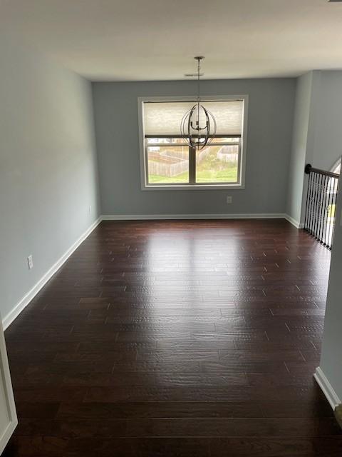 unfurnished dining area with a chandelier