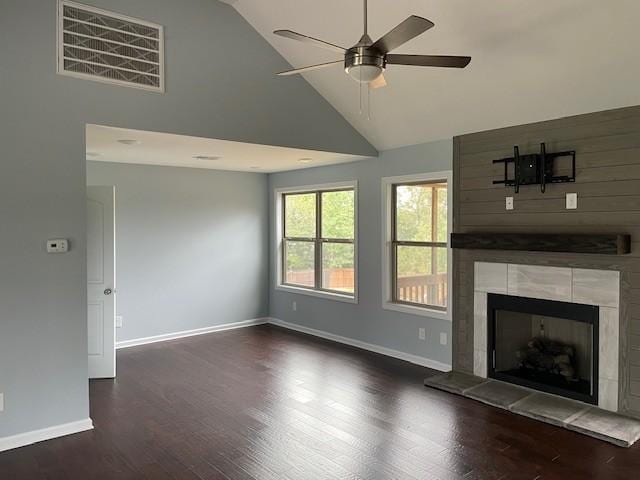 unfurnished living room with a tile fireplace, ceiling fan, dark hardwood / wood-style flooring, and high vaulted ceiling