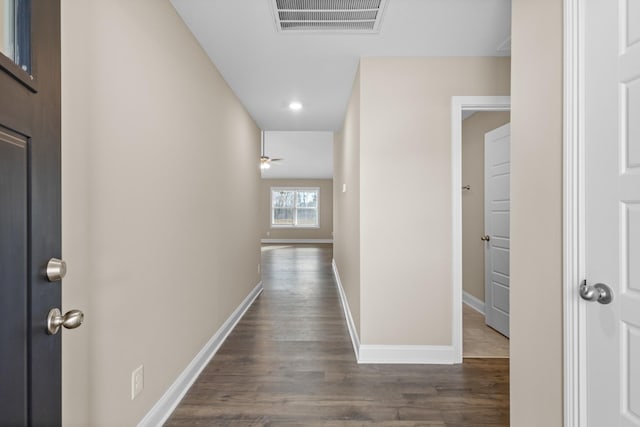 corridor with dark hardwood / wood-style flooring