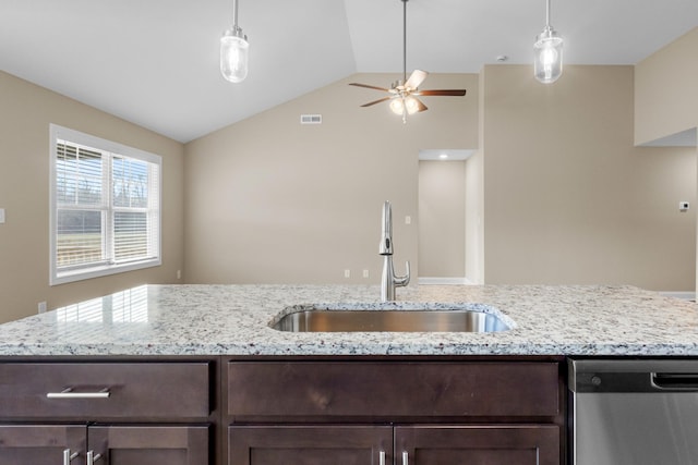 kitchen with dishwasher, light stone counters, lofted ceiling, and sink