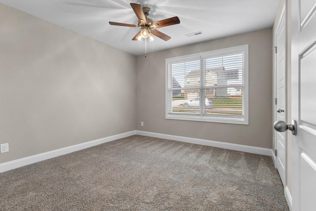 carpeted spare room featuring ceiling fan