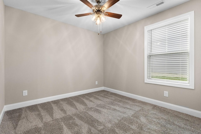 unfurnished room featuring ceiling fan and carpet floors