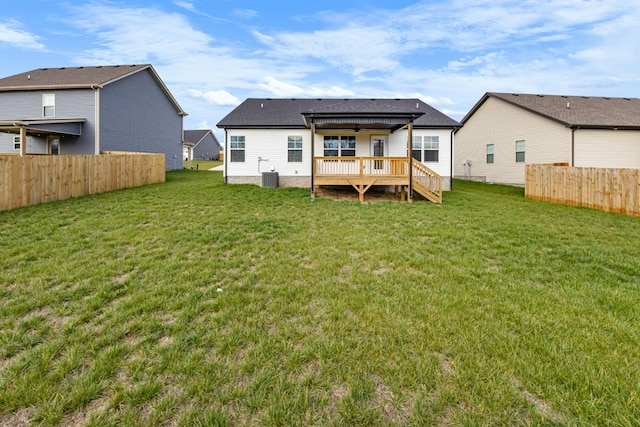 back of house with a lawn, a wooden deck, and central air condition unit