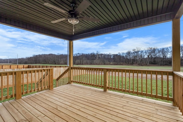 wooden deck featuring ceiling fan and a yard