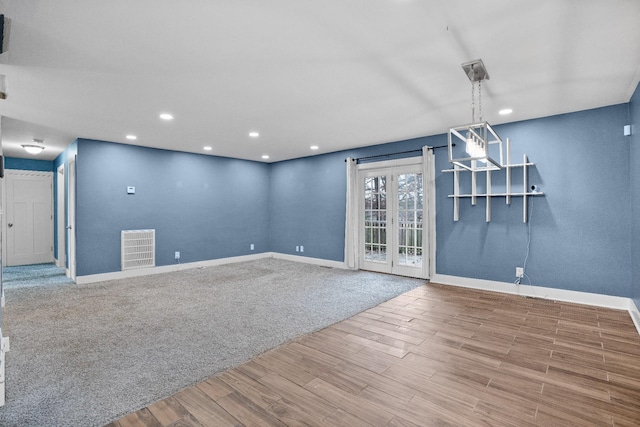 spare room with hardwood / wood-style floors and french doors