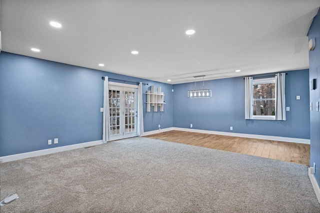 spare room featuring french doors and hardwood / wood-style flooring