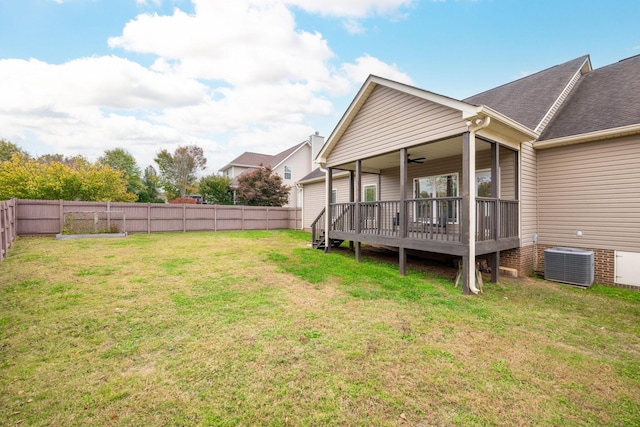 view of yard with ceiling fan, a wooden deck, and central AC