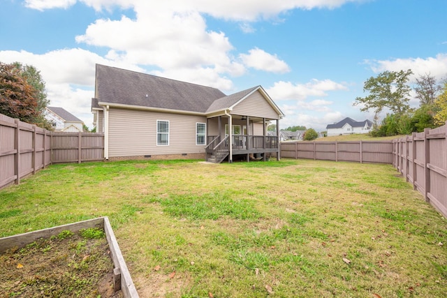 back of property with a yard and a deck