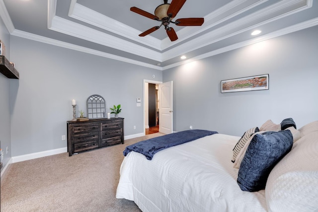 carpeted bedroom with ceiling fan, a raised ceiling, and crown molding