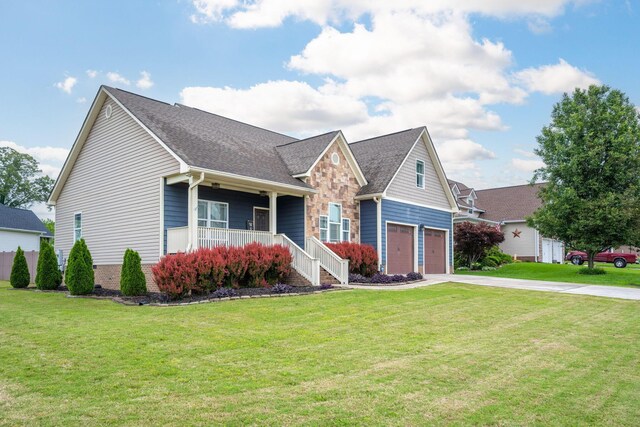 view of front facade featuring a porch, driveway, a front yard, stone siding, and stairs