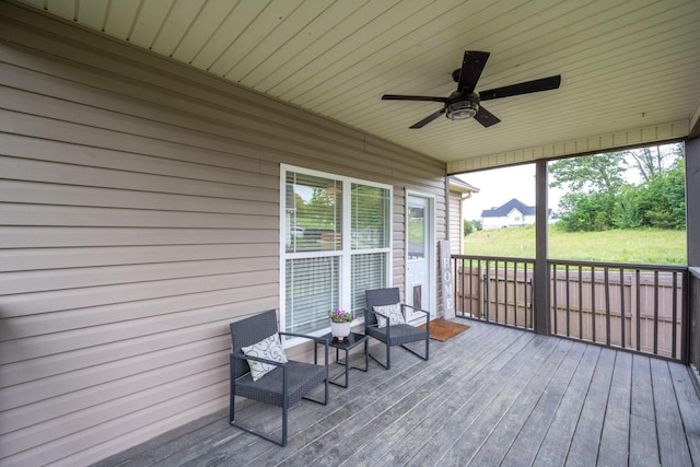 wooden deck with a ceiling fan