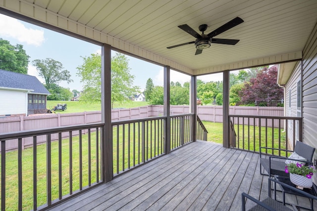 unfurnished sunroom with a ceiling fan